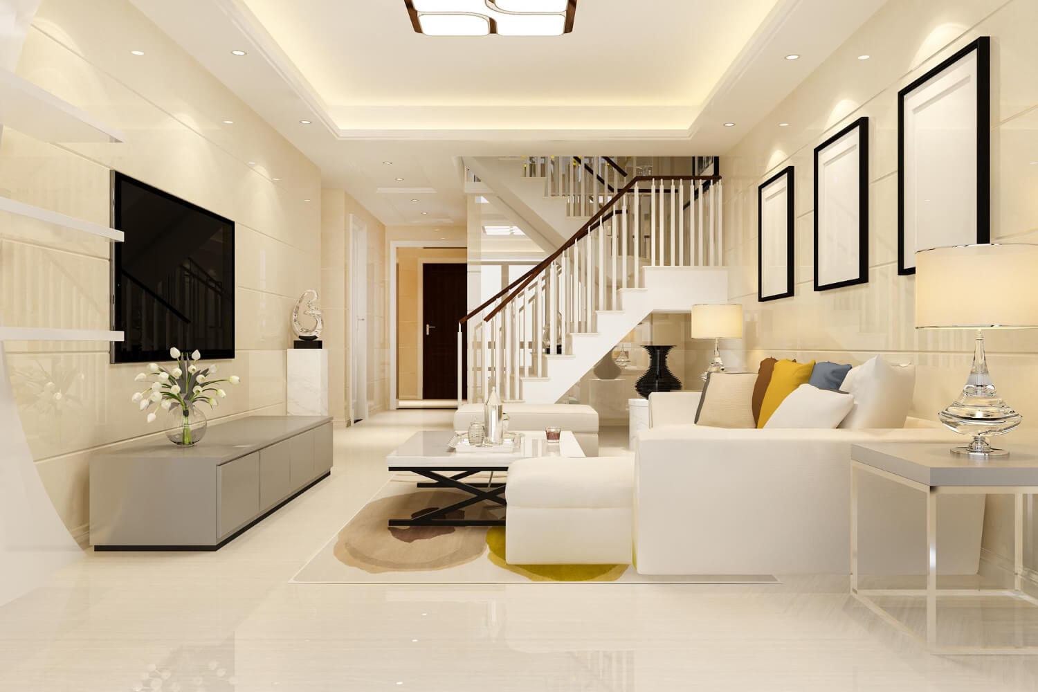 Modern living room with white furniture and staircase in a house.