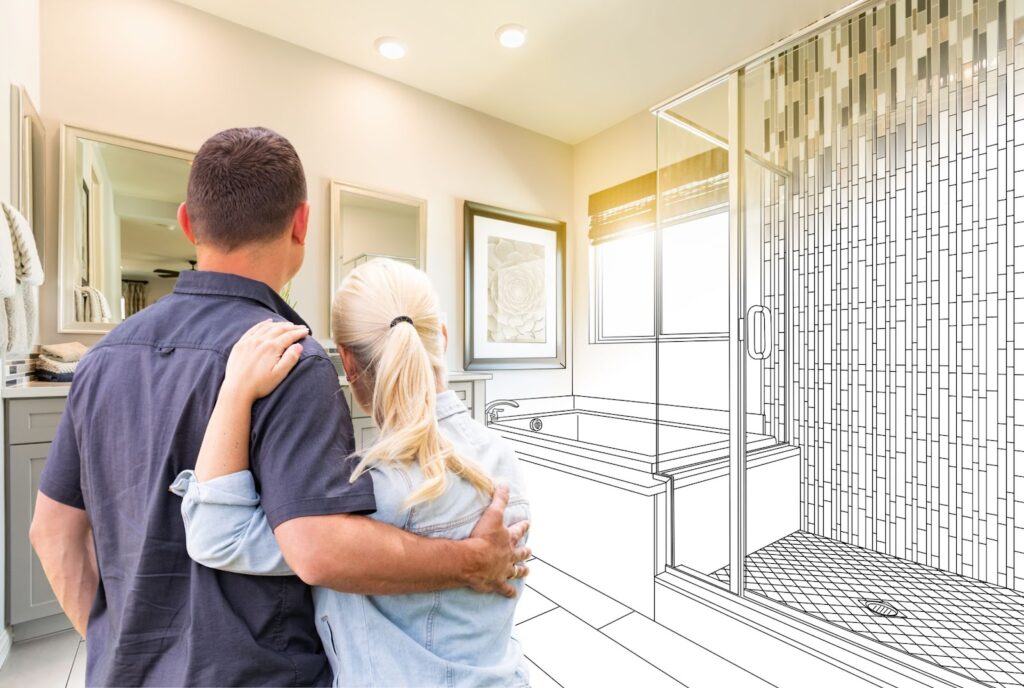 A couple admiring a bathroom sketch during a renovation project. Transform your bathroom with a remodel.