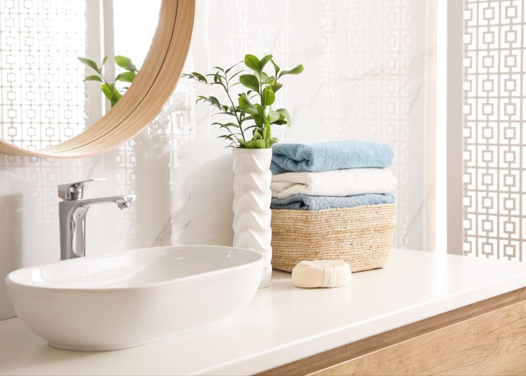 Bathroom-with-white-sink-and-wooden-mirror